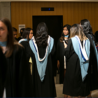 group of students in black graduation gowns