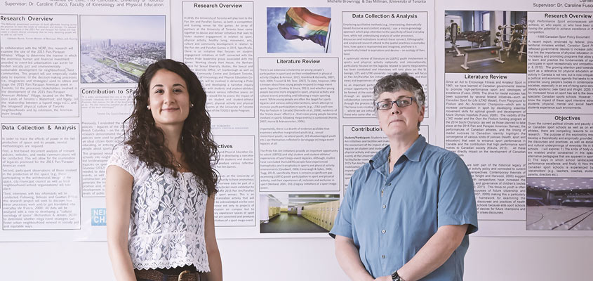 Professor and student in front of research poster