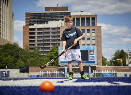 A young boy learns the fundamentals of field hockey