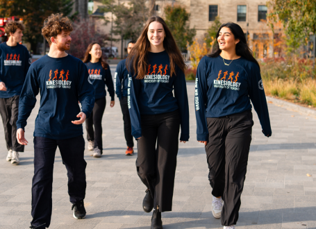 group of student ambassadors walking on front campus