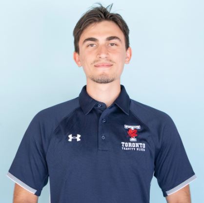 Headshot of Sam smiling in a U of T Varsity Blues shirt against a light blue background