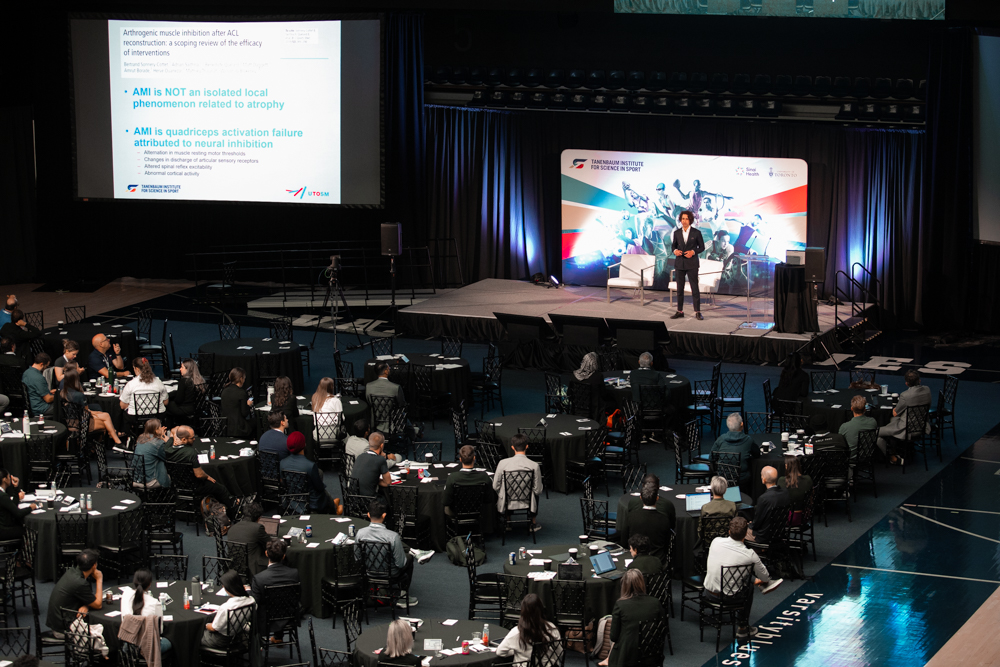 professor jas chahal speaks to conference attendees from stage