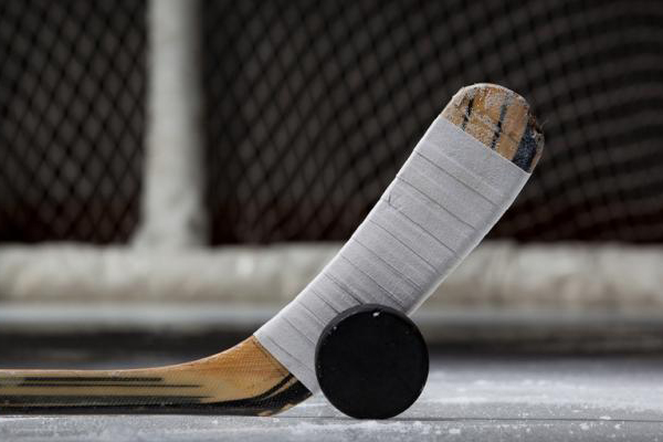 a hockey stick and puck on the ice