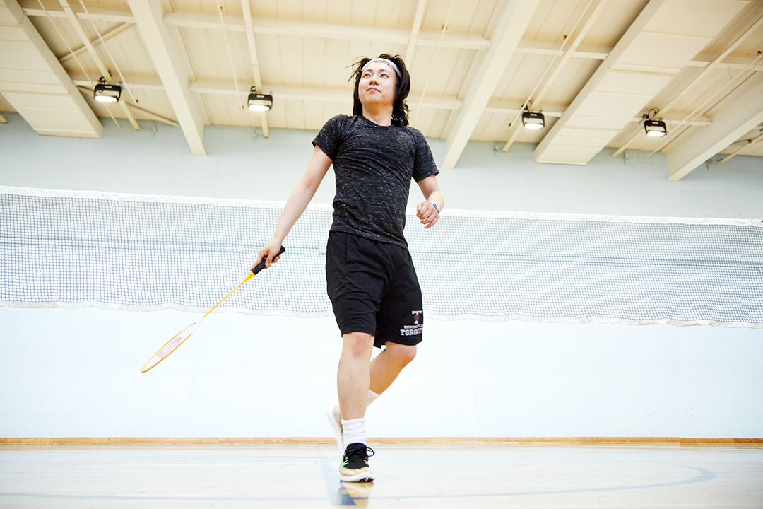young asian male with a badminton racket
