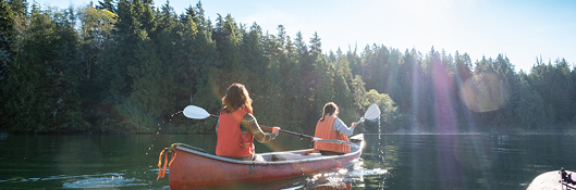 two women canoeing on sunny day