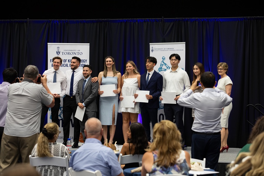 group of students on stage with awards at KPE convocation reception