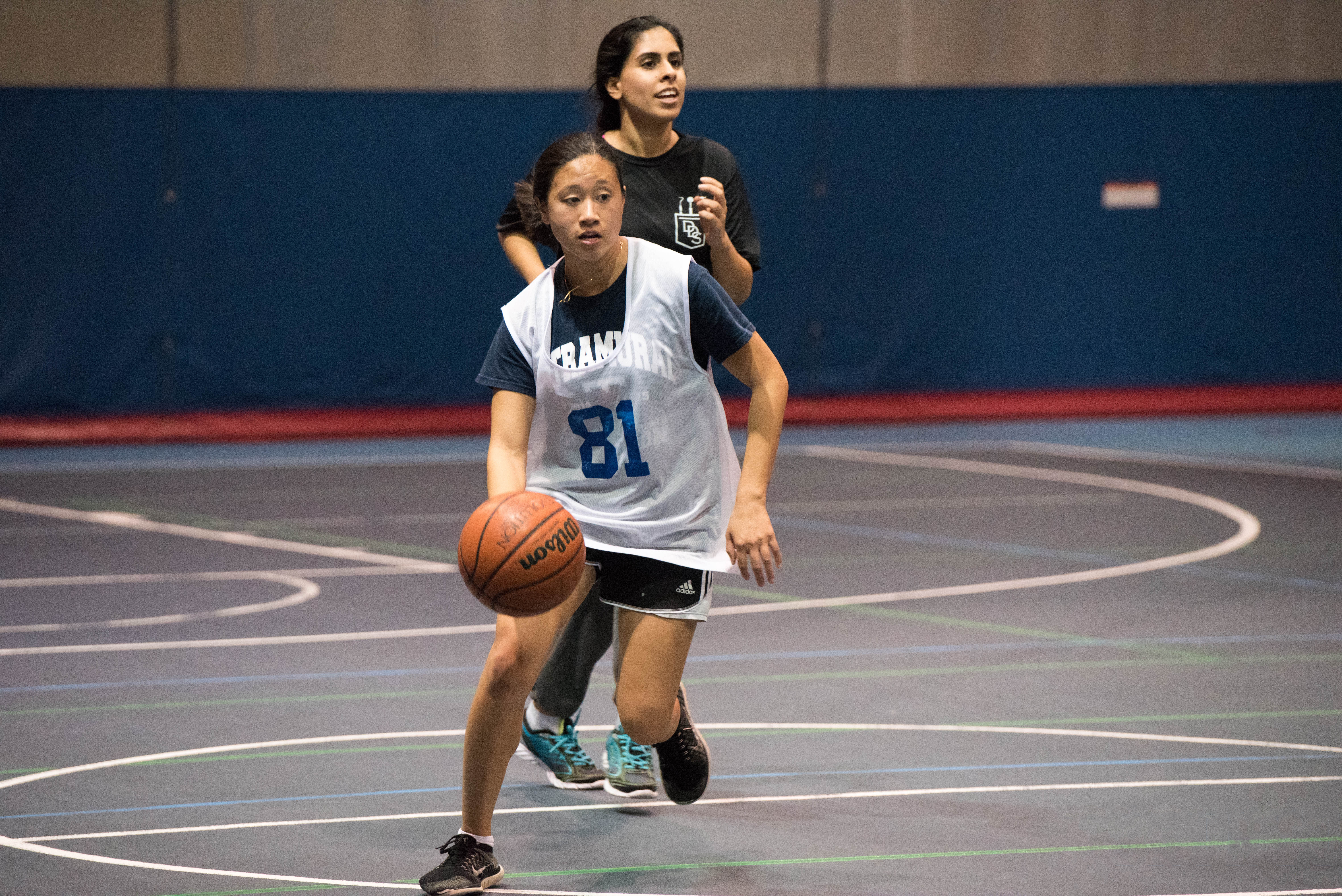 two women playing basketball