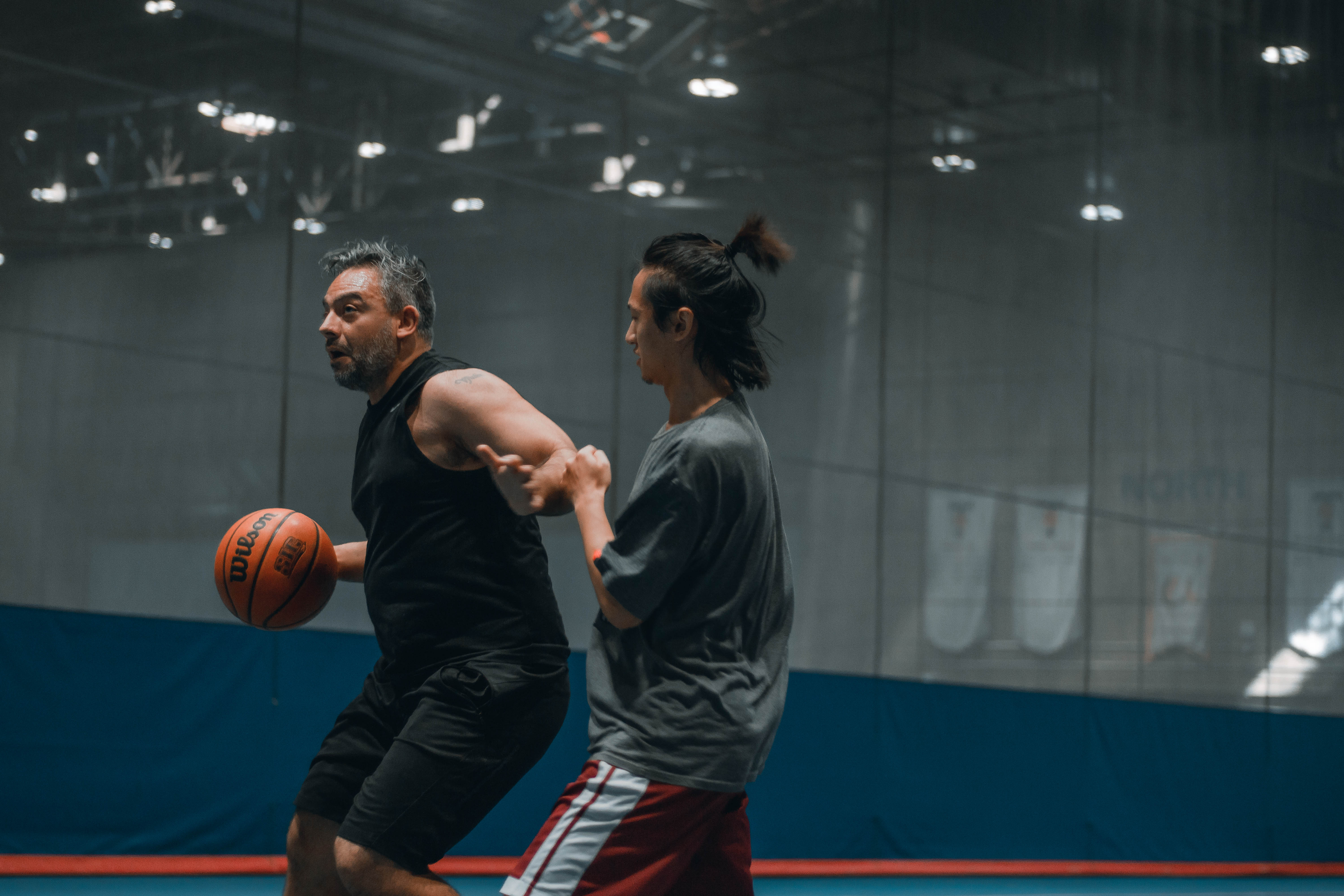 two men playing basketball in Athletic Centre Field House