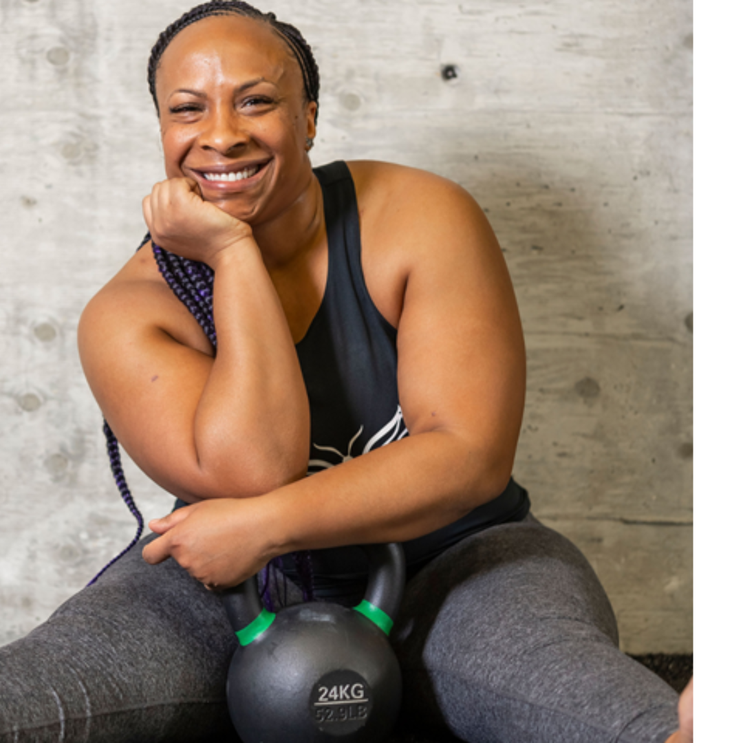 Photo of Damali Fraiser smiling with a kettle bell 