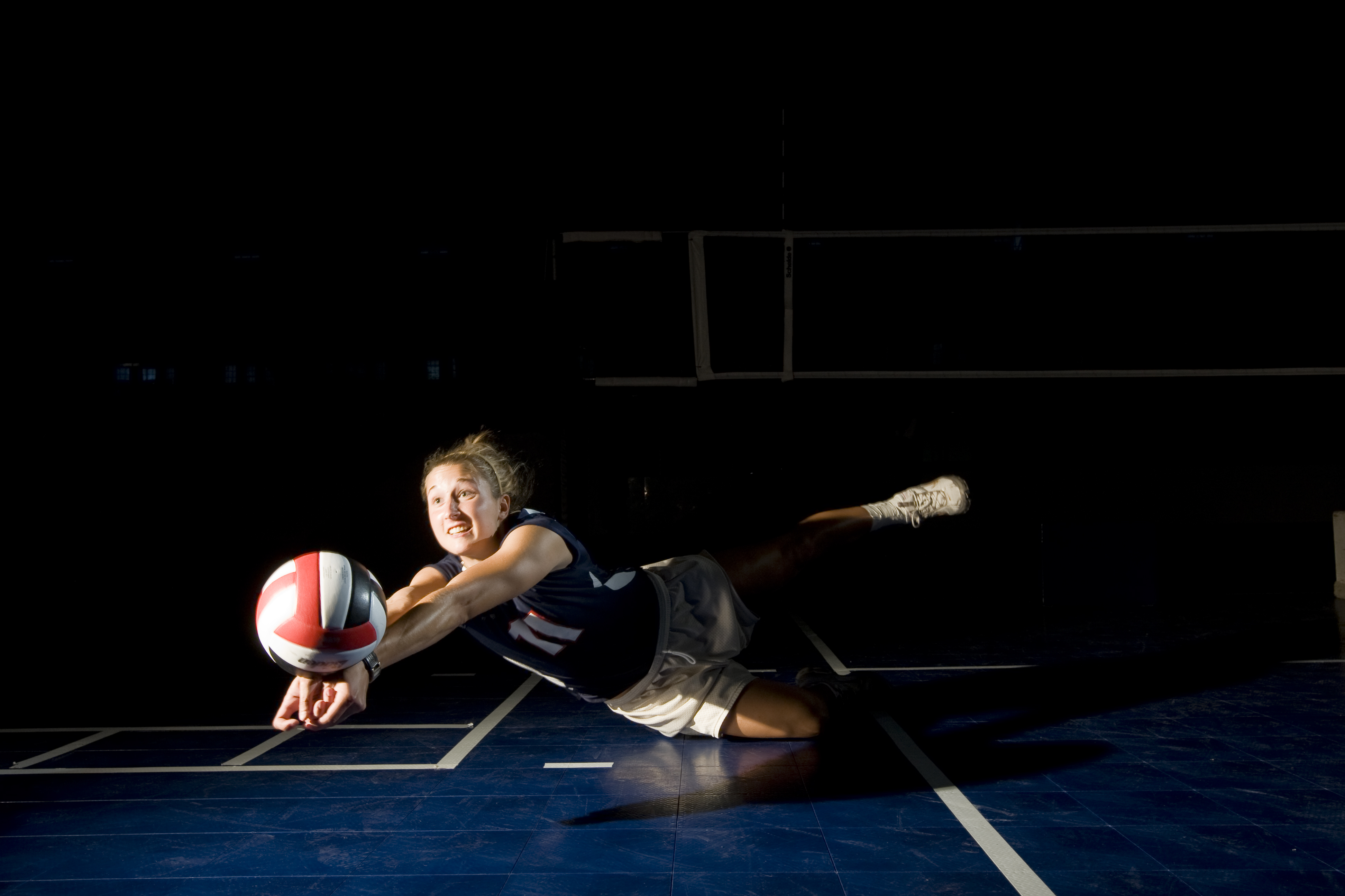 volleyball player diving to bump ball