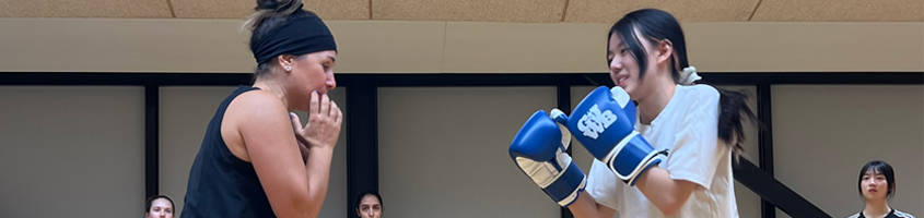 Two women fighting in boxing