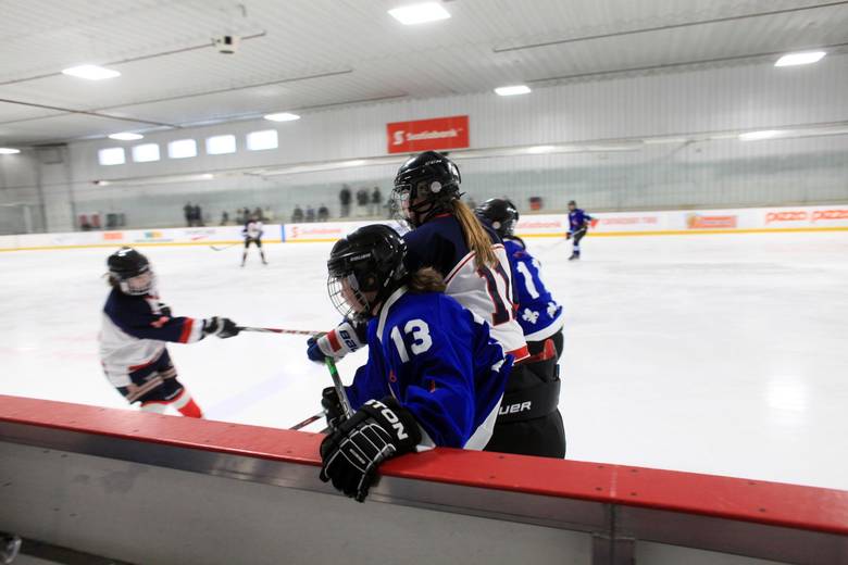 Nunavik Nordiks Noemie Koneak (13) is checked into the boards during a game