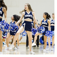 Women dancing in cheerleader uniforms