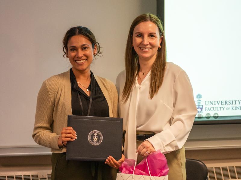 Aalaya Milne poses with Assistant Dean of Programs Ashley Stirling when receiving her Best Oral Presentation award.