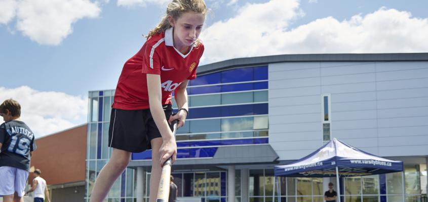 A young Girl learns the fundamentals of field hockey