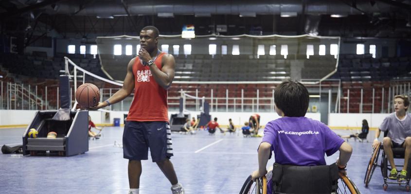 A boy plays wheelchair basketball