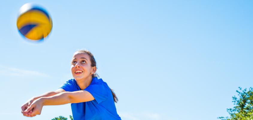 A girl playing beach volleyball