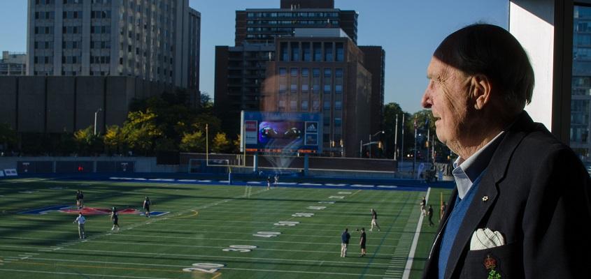 Adam Zimmerman takes in the view of the Varsity Stadium from the Zimmerman Room at the Varsity Centre