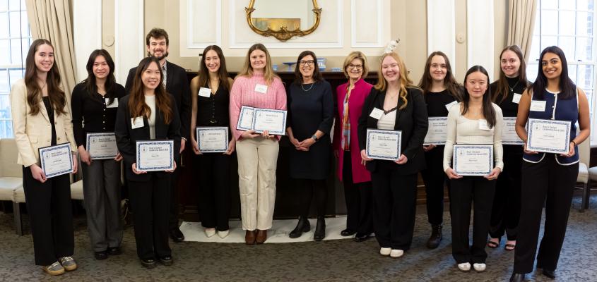 The 2025 Dean's Student Leadership Award winners from pose with their certificates and Dean Gretchen Kerr in the U of T Faculty Club.