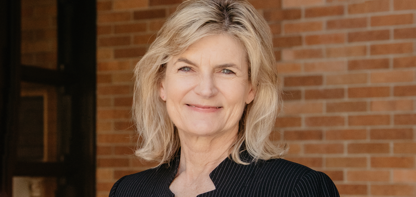 portrait of Dean Gretchen Kerr in front of brick wall