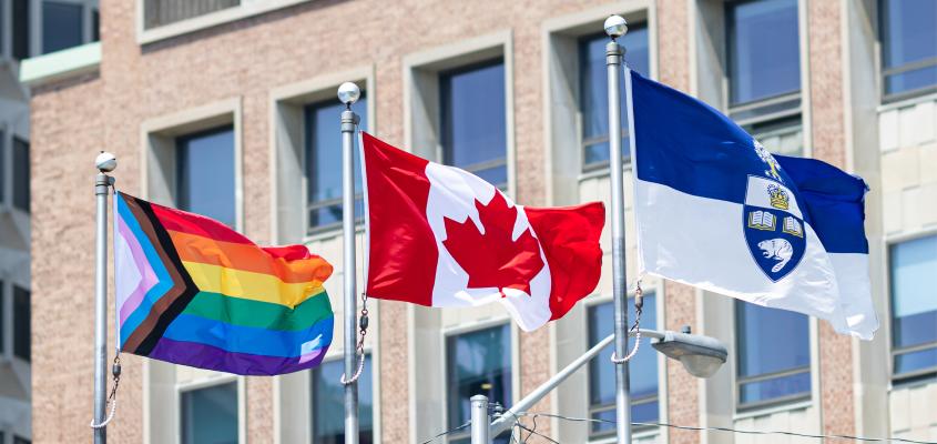 The Progress Pride flag flies alongside the flags of Canada and the University of Toronto