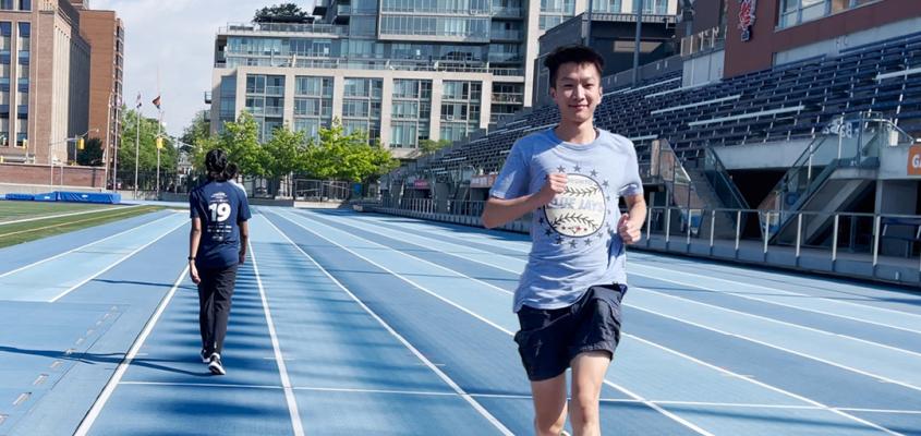 Students running at outdoor Varsity Centre track during drop-in jogging hours