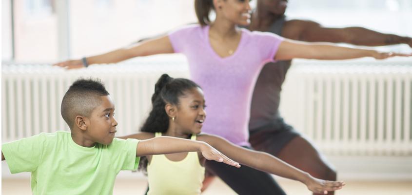 family of 4 holding yoga poses