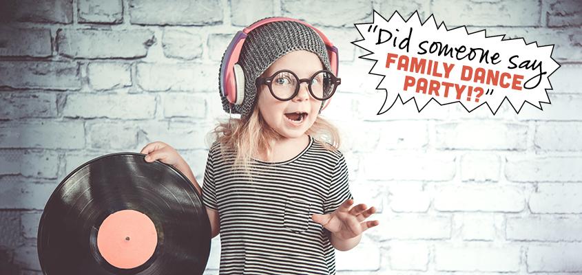 child holding record with headphones on