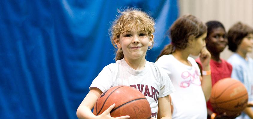 female child holding basketball