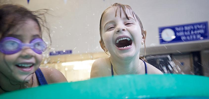 young female children playing in the pool