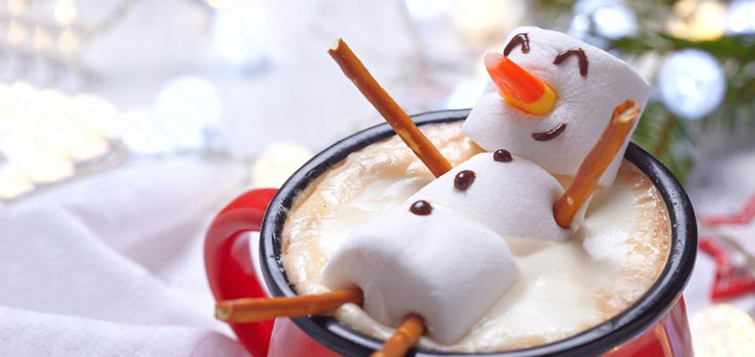 Snow man made of marshmallows in a  cup of hot chocolate