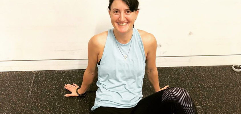 woman in athletic clothing sitting on floor