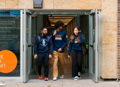 three student ambassadors exiting Clara Benson building